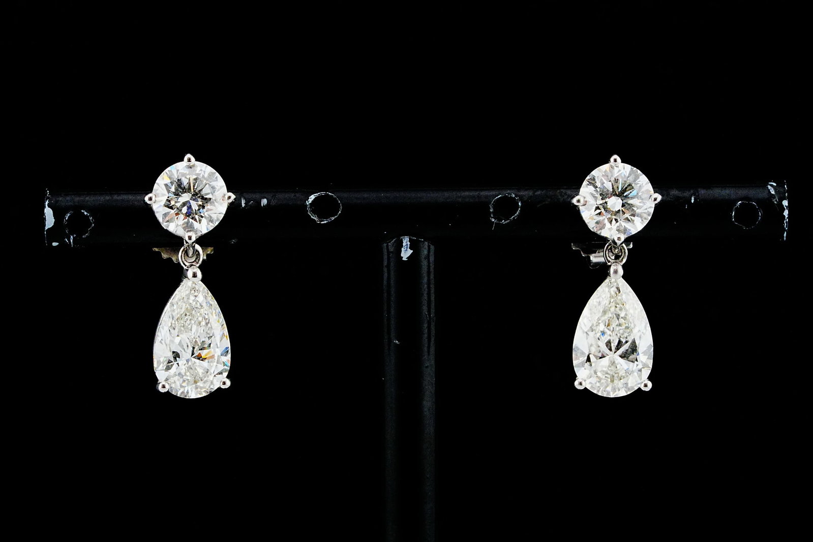 4.68ctw VS2-SI2/I Diamond and 18K White Gold Earrings: 4.68ctw VS2-SI2/I Diamond and 18K White Gold 0.50" Drop Earrings - Elegantly crafted in 18K white gold, these refined drop earrings showcase a beautifully matched pair of pear-shaped diamonds weighing