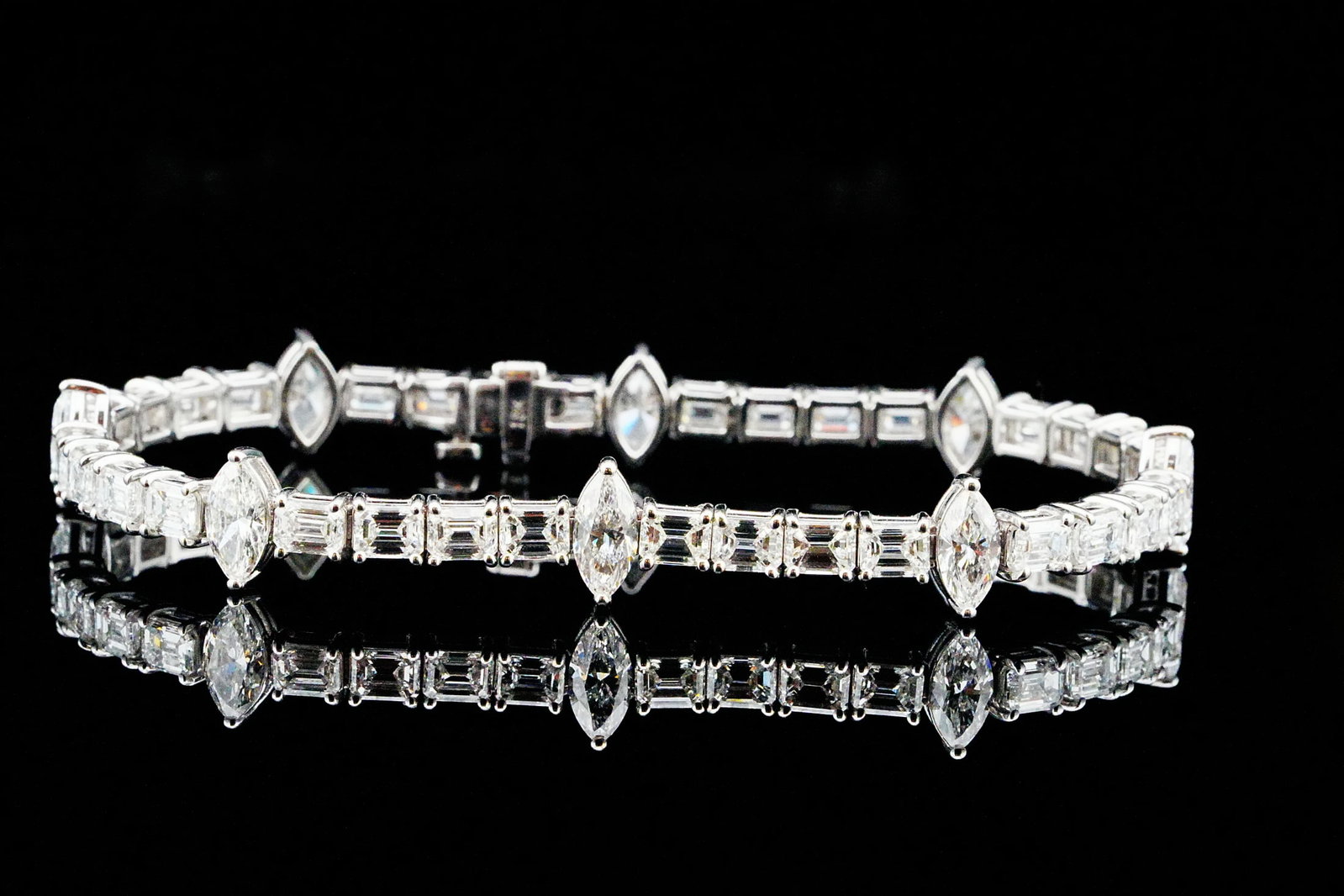 12.80ctw Emerald and Marquise-Cut Diamond 18K Bracelet: 12.80ctw VS1-SI1/G-H Emerald and Marquise-Cut Diamond 18K White Gold 8" Bracelet - A striking display of contemporary elegance and exceptional craftsmanship, this luxurious bracelet is fashioned in po