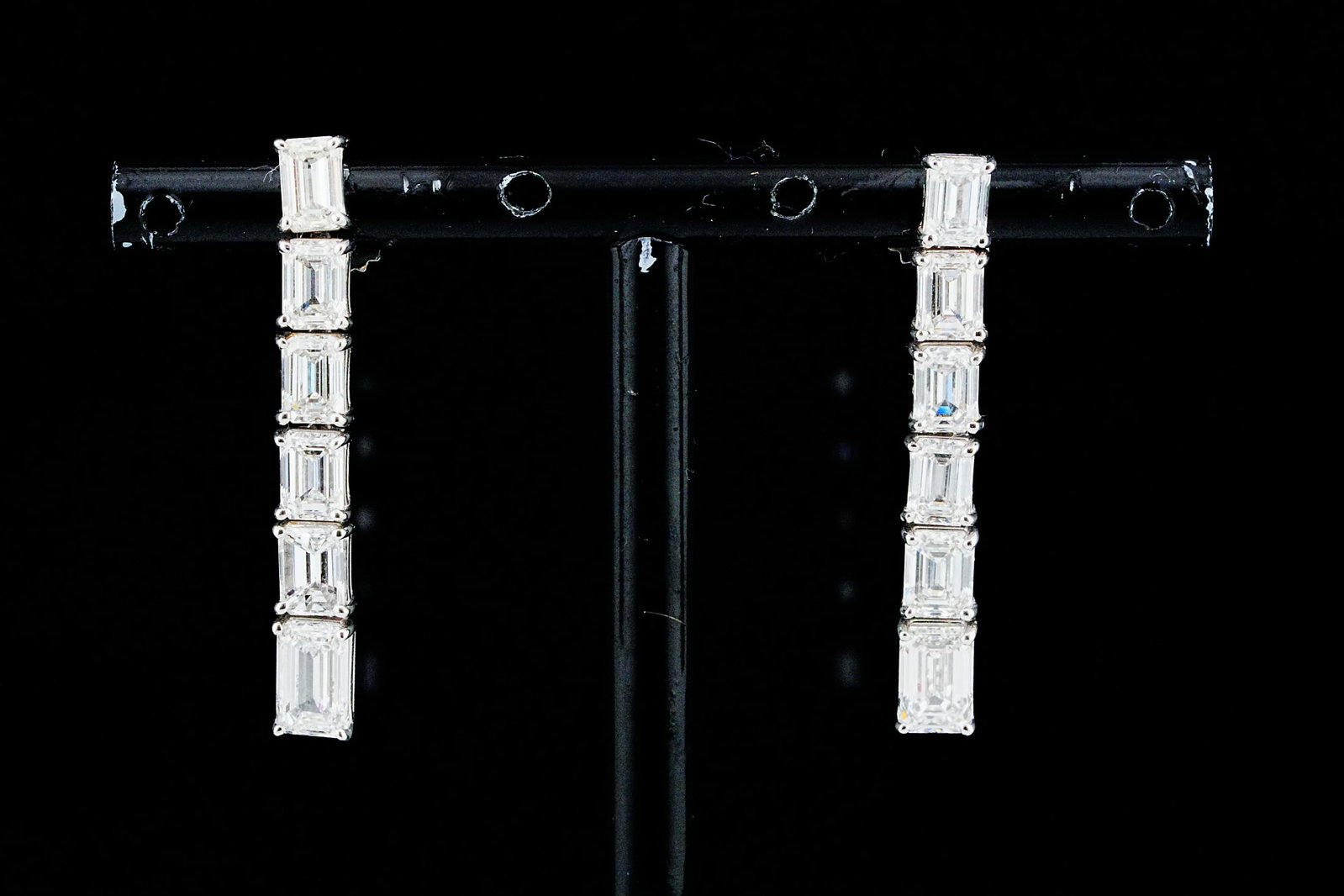 5.35ctw Emerald Cut Diamond and 18K 1.25" Earrings: 5.35ctw VS1-SI1/G-H Emerald Cut Diamond and 18K White Gold 1.25" Drop Earrings - A refined expression of contemporary elegance, these sophisticated 18K white gold drop earrings showcase a striking lin