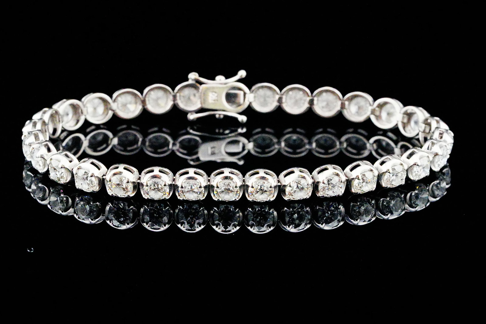9.35ctw Diamond and 18K White Gold 7" Bracelet: 9.35ctw VS1-SI1/G-H Diamond and 18K White Gold 7" Bracelet - An enduring symbol of elegance, this classic tennis bracelet is exquisitely crafted in polished 18K white gold and set with approximately 9