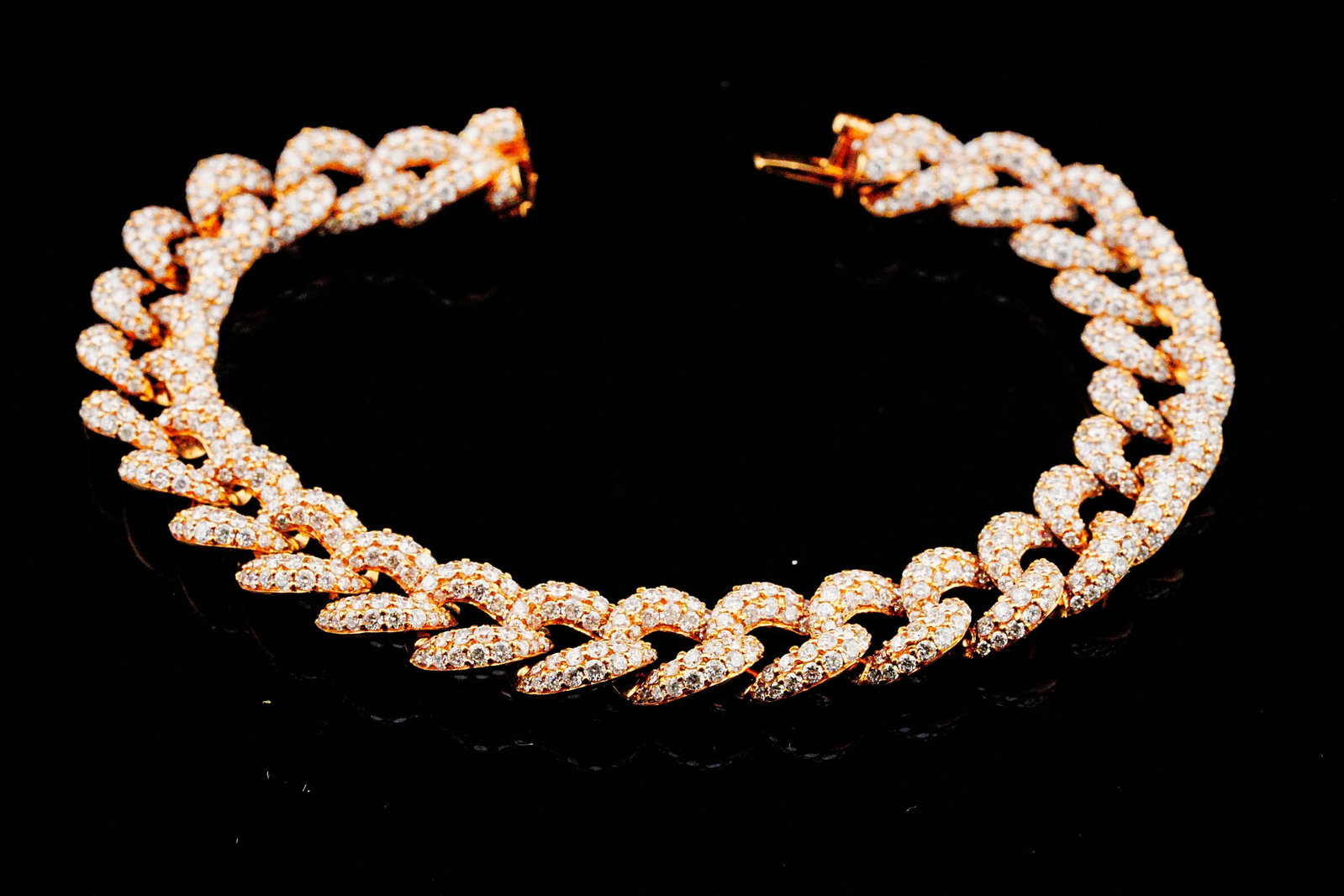 9.30ctw Diamond and 18K Rose Gold Cuban Link Bracelet: 9.30ctw VS1-SI1/G-H Pave Diamond and 18K Rose Gold 7" Cuban Link Bracelet - THIS ITEM WILL COME WITH A $37,000 INSURANCE VALUATION REPORT. Crafted in warm 18K rose gold, this Cuban link bracelet featu