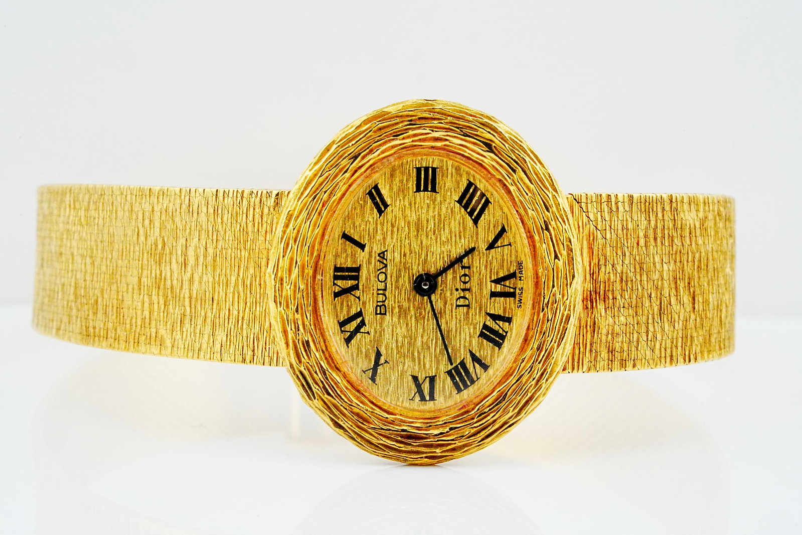 Bulova for Dior 1960s 28mm Solid 18K Barked Gold Watch: Bulova for Dior 1960s 28mm Solid 18K Yellow Barked Gold Vintage Watch - A striking 1960s vintage timepiece from the distinguished Bulova for Dior collaboration, crafted in solid 18K yellow gold and sh