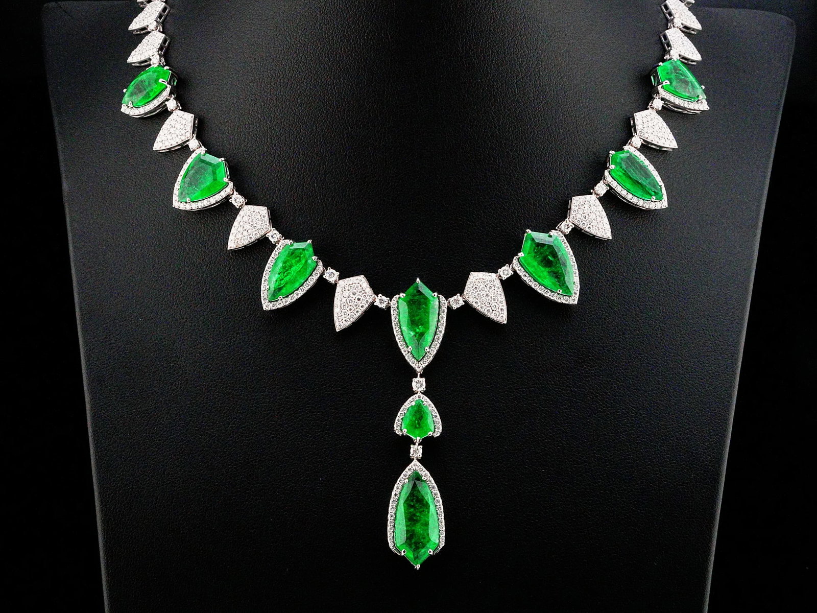34.00ctw Emerald, 5.60ctw Diamond and 18K 16" Necklace: 34.00ctw Emerald, 5.60ctw VS1-SI1/G-H Diamond and 18K White Gold 16" Necklace - THIS ITEM WILL COME WITH A $130,000 INSURANCE VALUATION REPORT. A spectacular statement of high jewelry artistry, this e