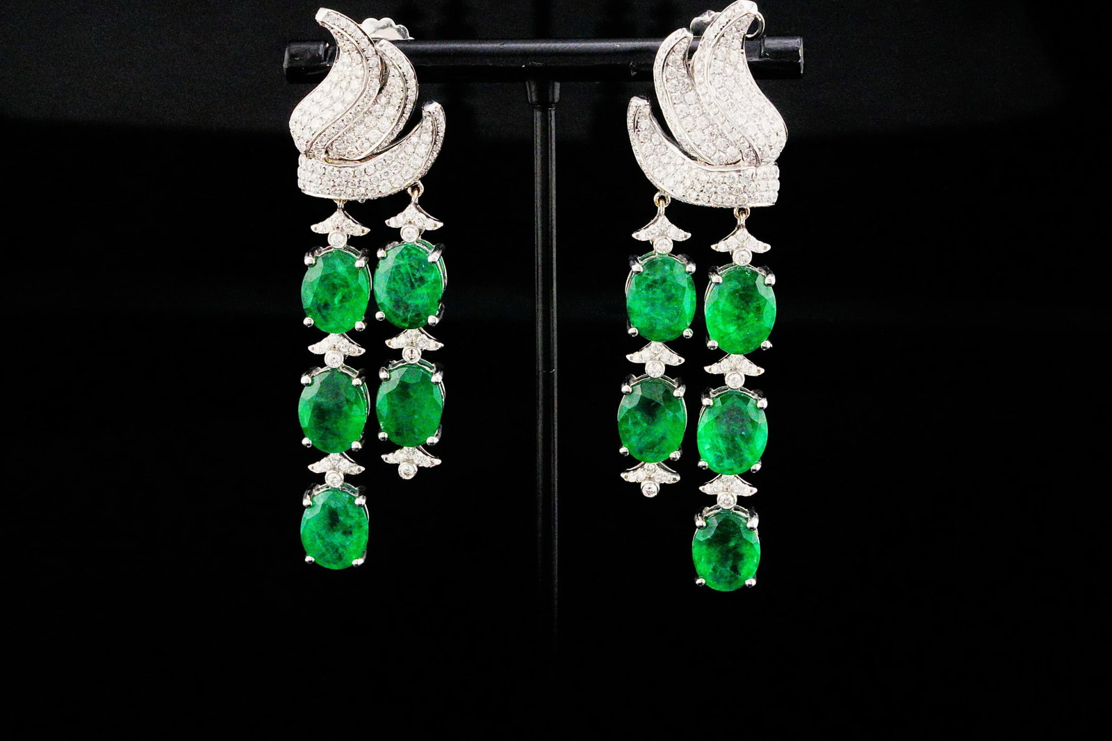 25.60ctw Emerald, 4.00ctw Diamond and 18K 2.75" Earrings: 25.60ctw Emerald, 4.00ctw VS1-SI1/G-H Diamond and 18K White Gold 2.75" Chandelier Earrings - THIS ITEM WILL COME WITH A $43,000 INSURANCE VALUATION REPORT. A breathtaking expression of contemporary ha
