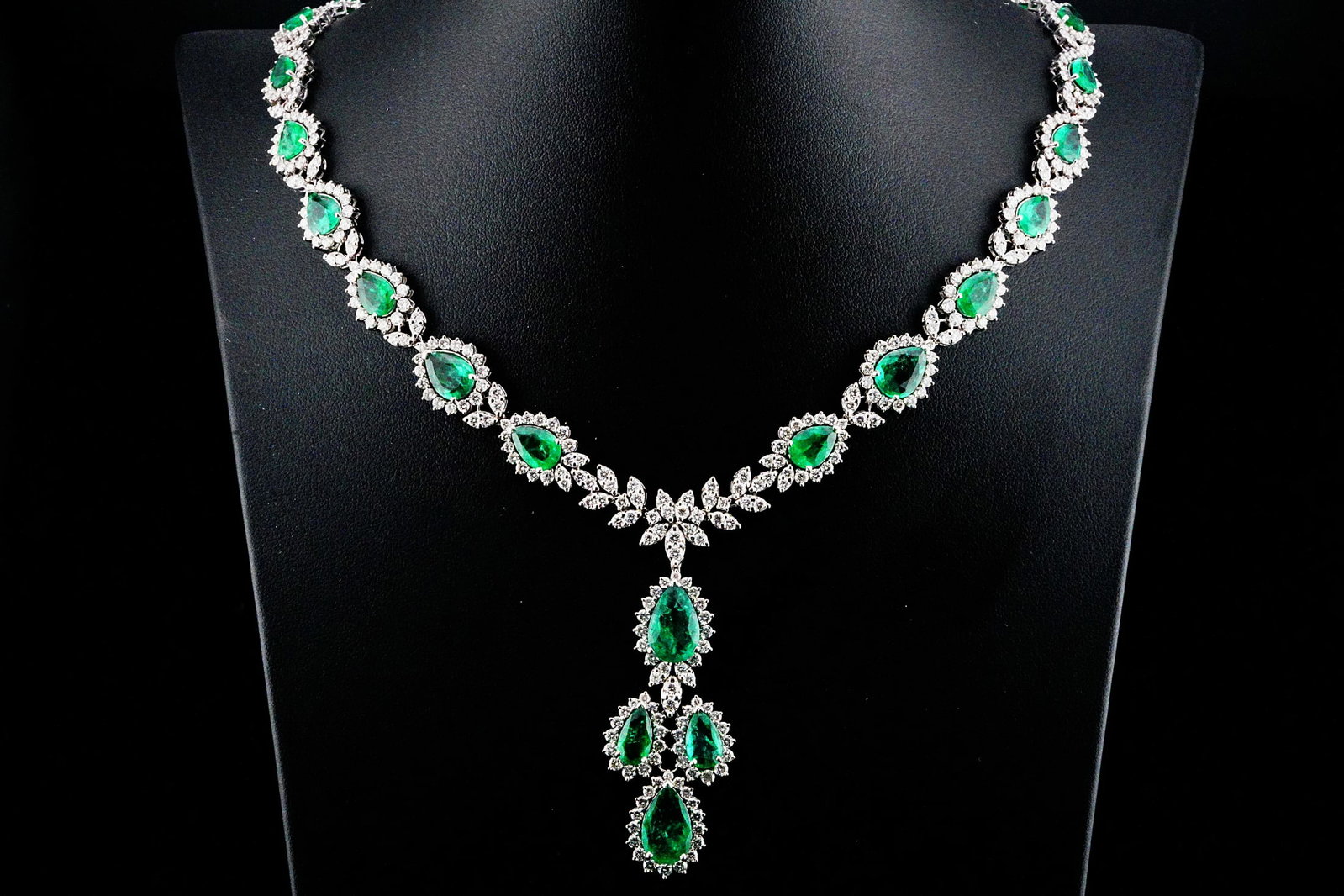29.85ctw Emerald, 16.40ctw Diamond and 18K Necklace: 29.85ctw Emerald, 16.40ctw VS1-VS2/G-H Diamond and 18K White Gold 18" Riviere Pendant Drop Necklace - THIS ITEM WILL COME WITH A $110,000 INSURANCE VALUATION REPORT. This magnificent high-jewelry neck
