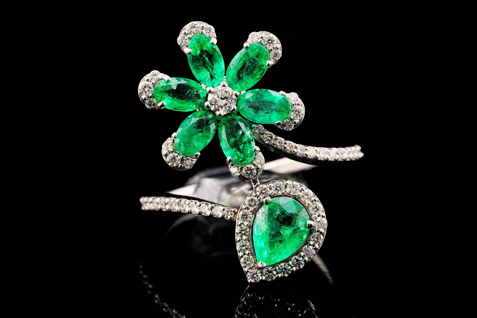 2.00ctw Emerald, 0.50ctw Diamond and 18K Floral Ring: 2.00ctw Emerald, 0.50ctw Diamond and 18K White Gold Floral Bypass Ring - THIS ITEM WILL COME WITH A $7,500 INSURANCE VALUATION REPORT. Gracefully blending botanical inspiration with contemporary elega