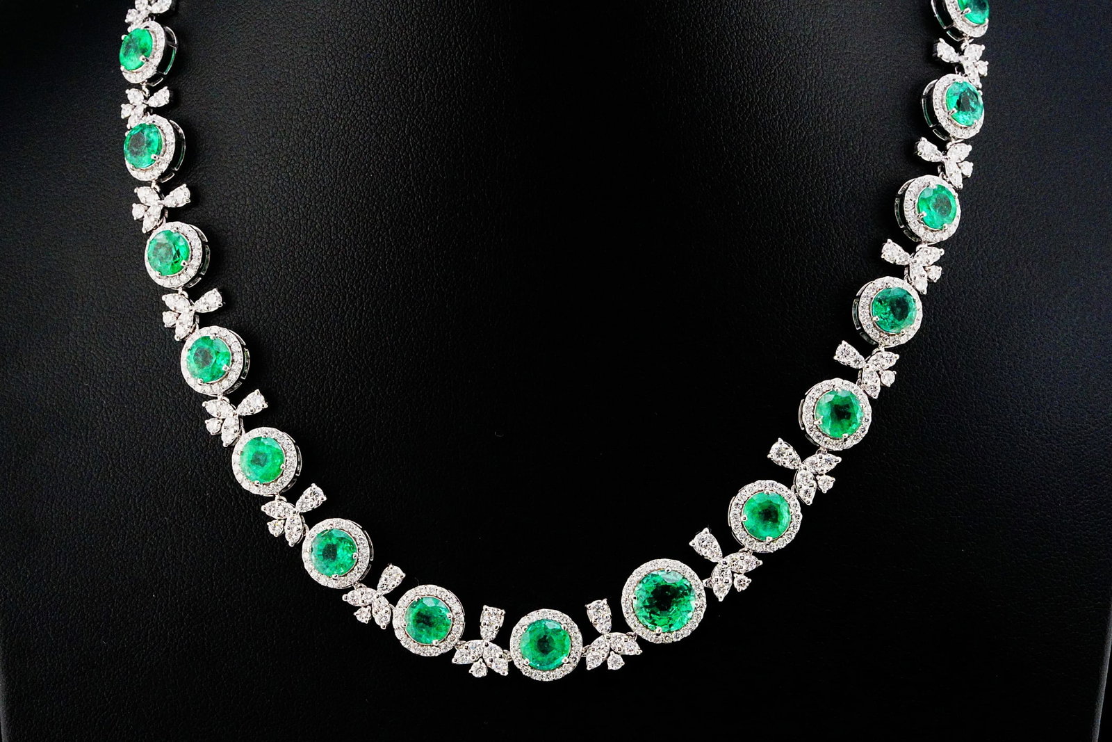 21.90ctw Emerald, 8.25ctw Diamond and 18K 15.5" Necklace: 21.90ctw Emerald, 8.25ctw VS1-SI1/G-H Diamond and 18K White Gold 15.5" Necklace - THIS ITEM WILL COME WITH A $83,000 INSURANCE VALUATION REPORT. This extraordinary 18K white gold necklace showcases ap