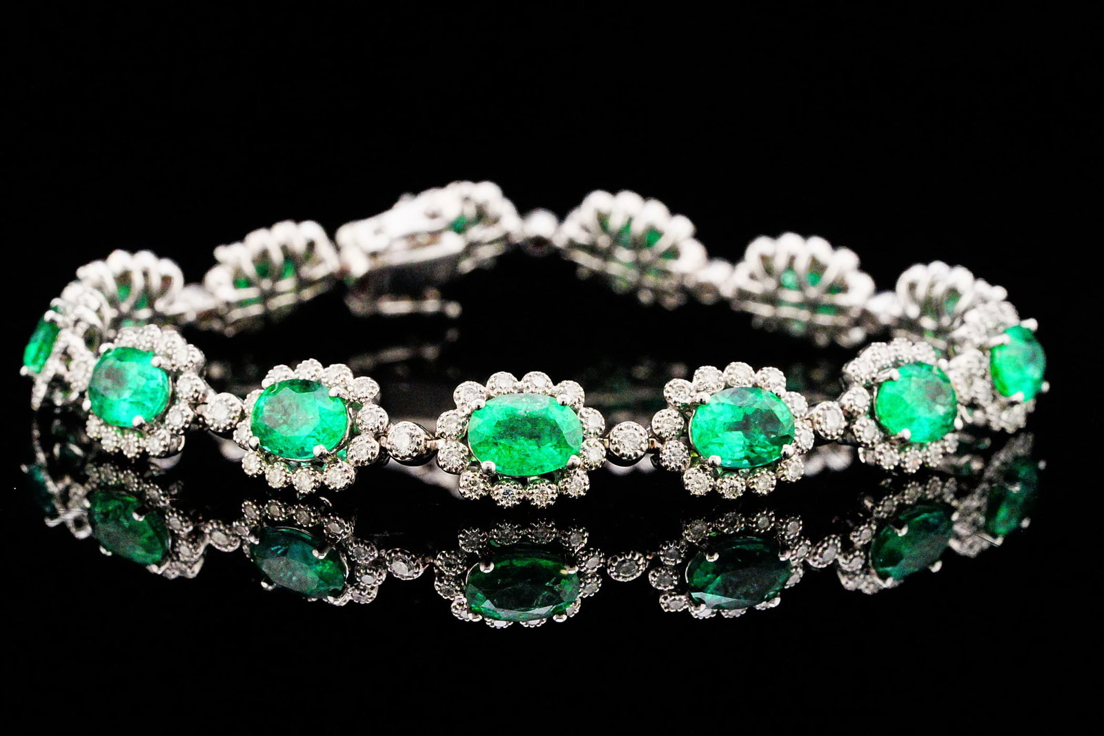 9.60ctw Emerald, 1.65ctw Diamond and 18K Bracelet: 9.60ctw Emerald, 1.65ctw VS2-SI1/G-H Diamond and 18K White Gold 6.75" Bracelet - THIS ITEM WILL COME WITH A $37,500 INSURANCE VALUATION REPORT. A timeless showcase of elegance and vibrant color, this 