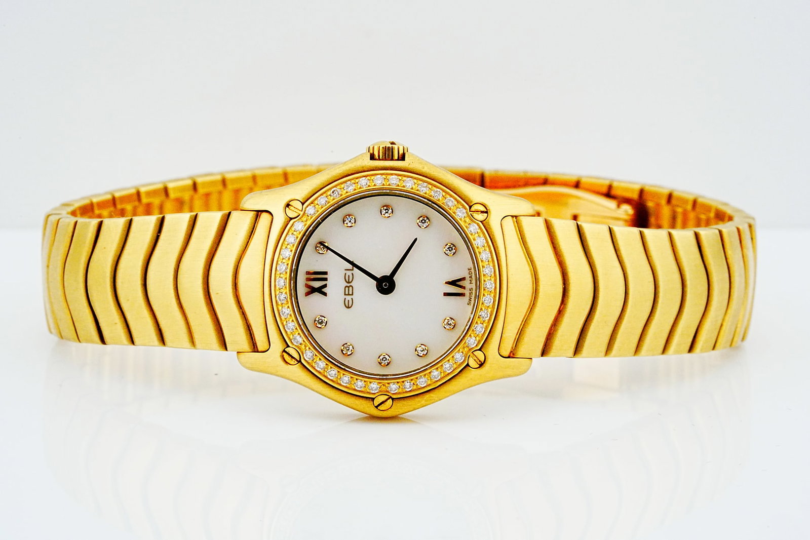 Ebel Classic Wave 24mm 18K Diamond Watch Ref. E8157F14: Ebel Classic Wave 24mm Solid 18K Yellow Gold Diamond Bezel Quartz Watch Ref. E8157F14 - An exquisite Ebel Classic Wave timepiece showcasing the maison's signature sculptural design in solid 18K yellow