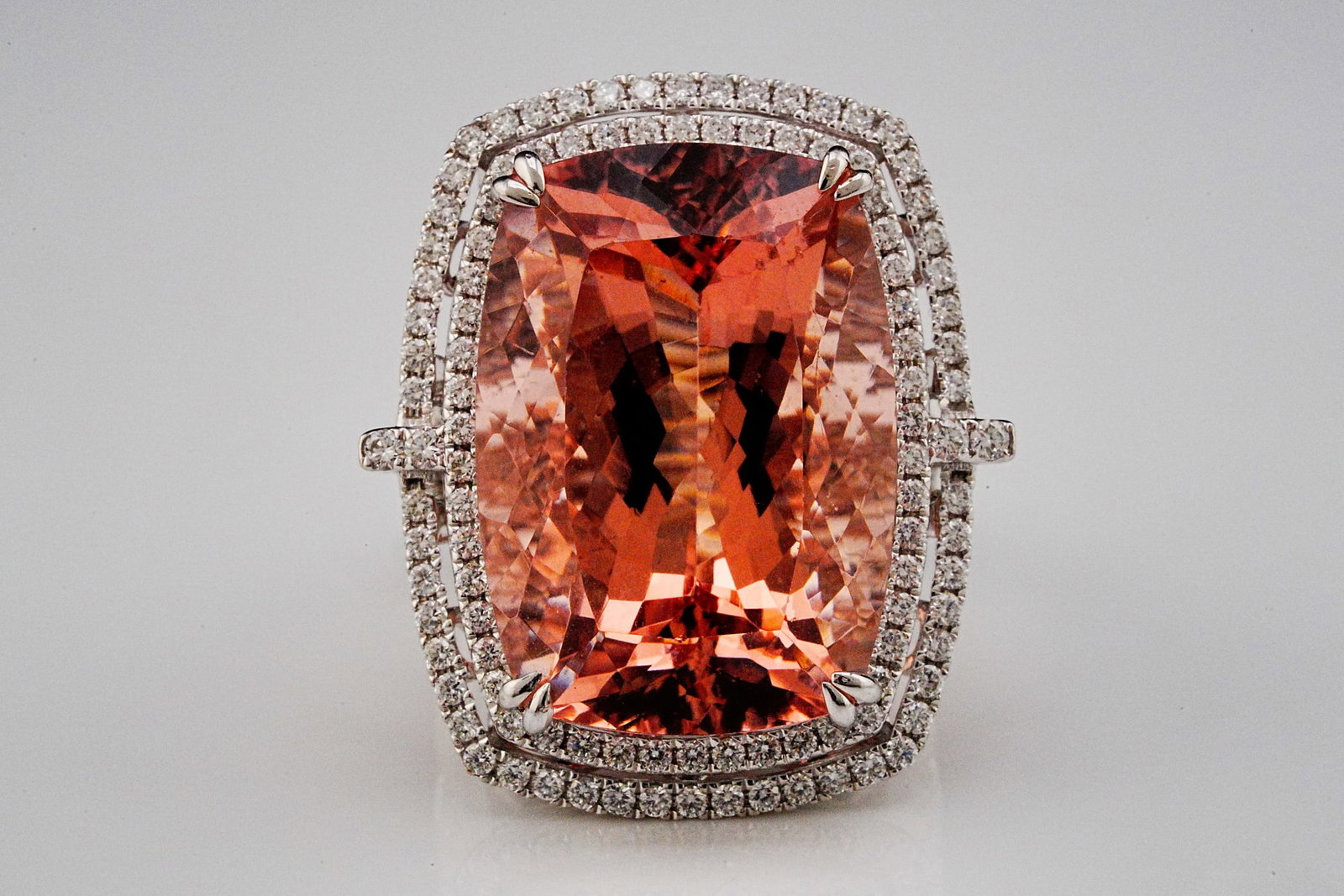 33.80ct Morganite, 1.75ctw Diamond and 18K Ring: 33.80ct Morganite, 1.75ctw VS1-VS2/G-H Diamond and 18K White Gold Cocktail Ring - THIS ITEM WILL COME WITH A $27,500 INSURANCE VALUATION REPORT. This breathtaking 18K white gold ring is centered by