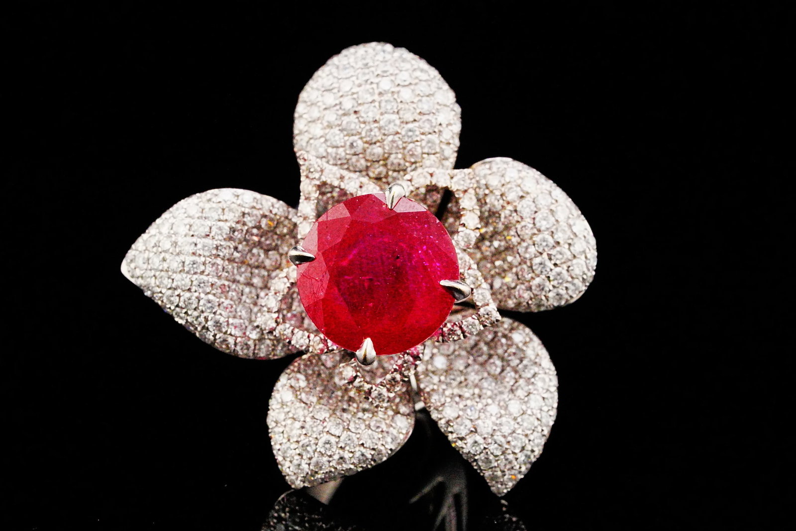 13.65ct Ruby, 5.65ctw VS1-SI1/G-H Diamond and 18K Ring: 13.65ct Ruby, 5.65ctw VS1-SI1/G-H Diamond and 18K White Gold Flower Ring - THIS ITEM WILL COME WITH A $26,000 INSURANCE VALUATION REPORT. A magnificent floral masterpiece, this extraordinary ring is c