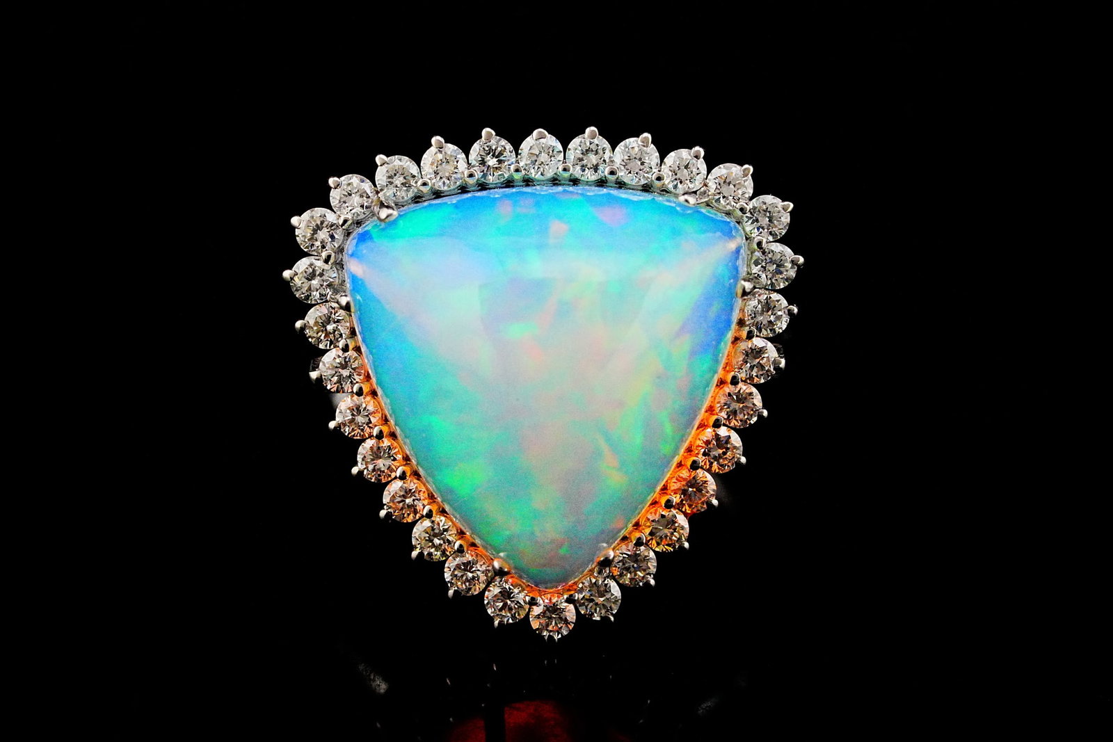 10.30ct Opal, 0.80ctw VS1-VS2/G-H Diamond and 18K Ring: 10.30ct Opal, 0.80ctw VS1-VS2/G-H Diamond and 18K White Gold Ring - THIS ITEM WILL COME WITH A $8,000 INSURANCE VALUATION REPORT. A mesmerizing statement piece, this exceptional ring showcases a breat