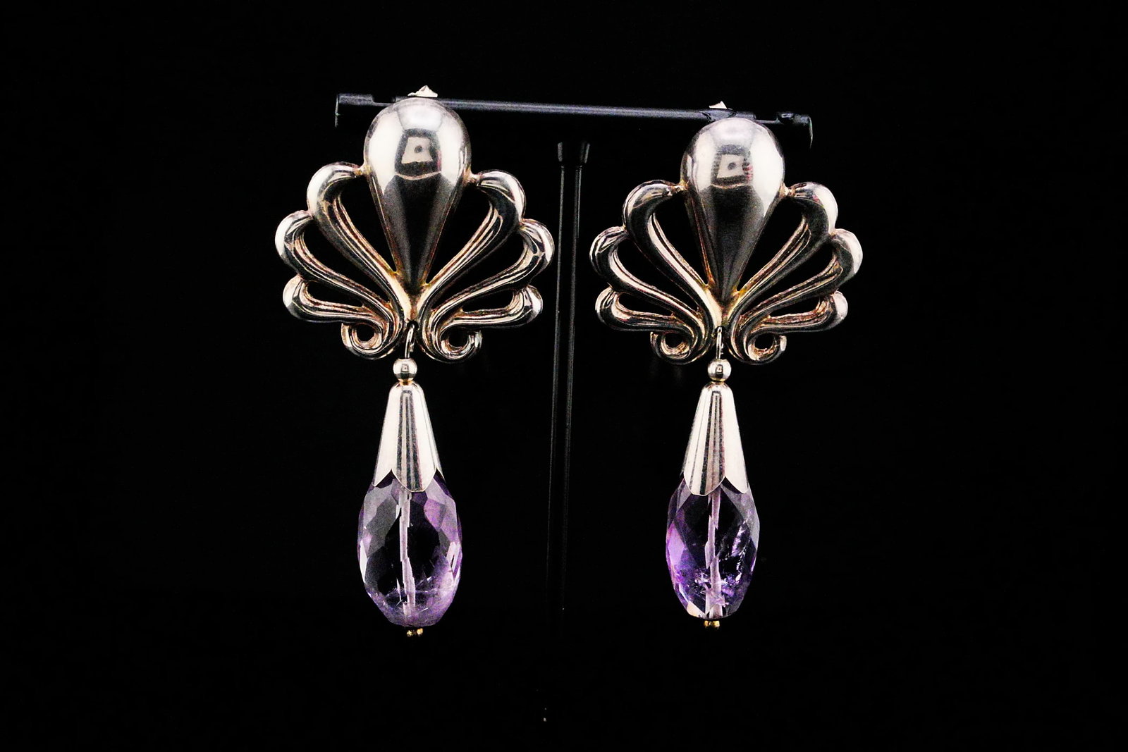 22ctw Amethyst and Sterling Silver 2.75" Earrings: 22.00ctw Amethyst and Sterling Silver 2.75" Dangle Earrings - These elegant sterling silver dangle earrings showcase approximately 22.00 carats of richly hued amethyst briolettes. The expertly faceted