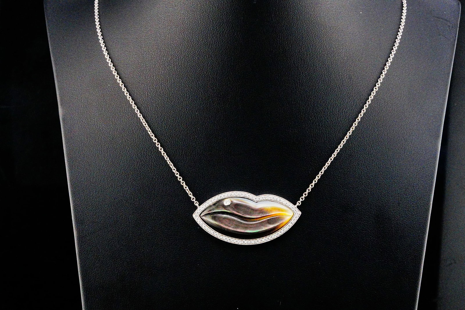 Sterling Silver and Mother of Pearl 24" Lips Necklace: Sterling Silver and Carved Tahitian Mother of Pearl 24" Lips Necklace W/Crystal Accents - Crafted in sterling silver with an attached carved Tahitian mother of pearl lips pendant accented with fiery