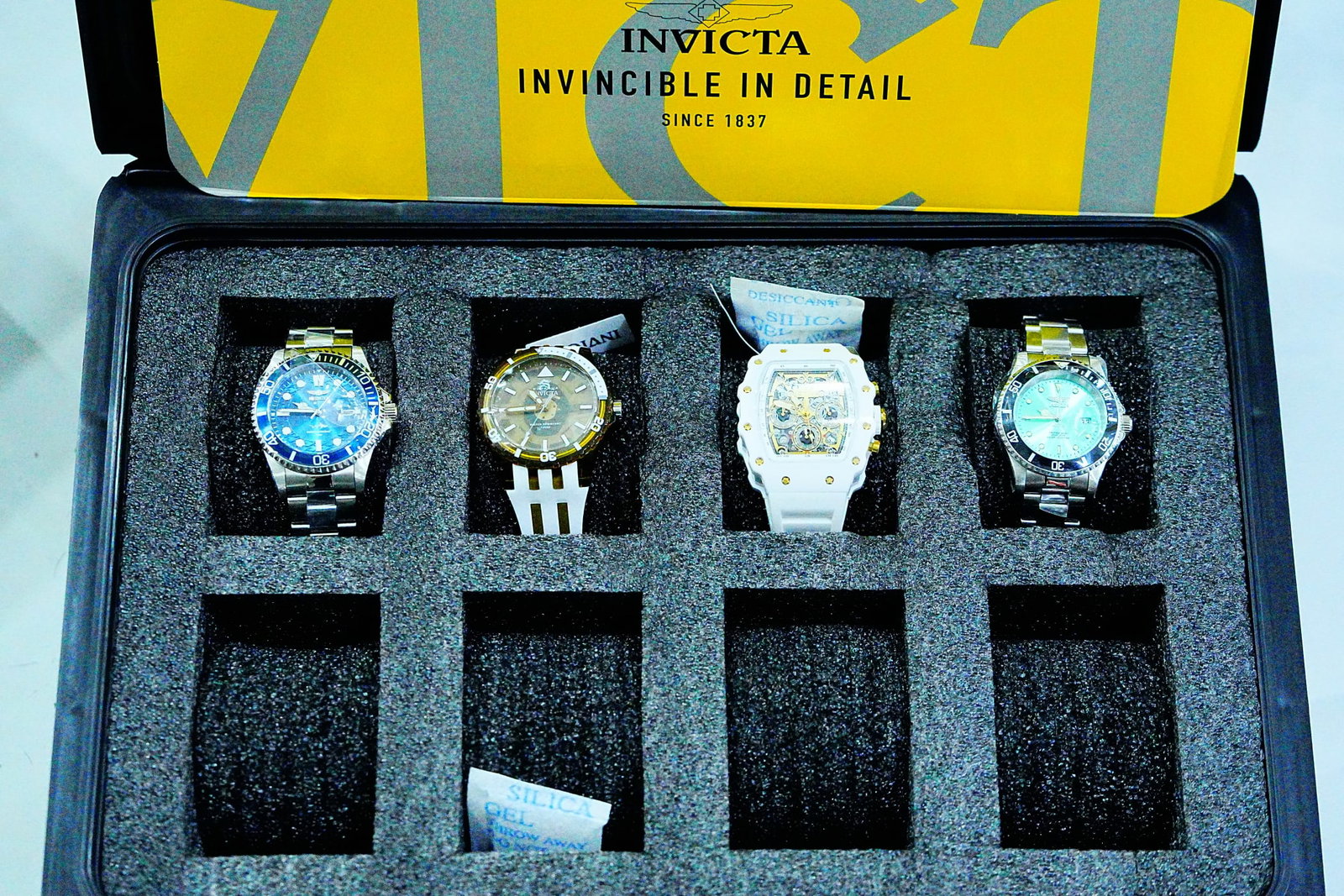 (4) Unworn Invicta Watches in Official Invicta Dive Case: Lot of (4) Unworn Invicta Wristwatches with Original Tags in Official Invicta 8-Slot Collector's Dive Case - An impressive collector's assortment featuring four unworn Invicta wristwatches, each retai