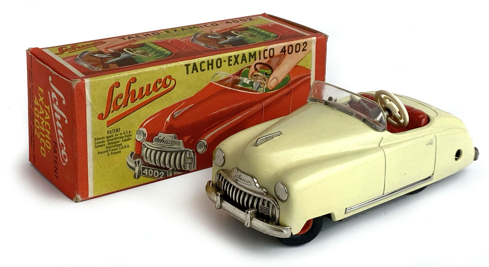 Schuco Tacho Examico 4002: Ditta Schuco, Germania, anni '50. Prima serie. Modello in latta serigrafata con ruote e particolari in plastica. Lunghezza cm 15x6,5. Annunciata come il modello di auto piÃ¹ moderno e tecnicamente m