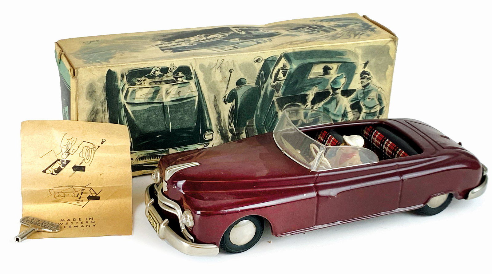 Convertible Candidat Arnold: Ditta Arnold, Germania, anni '50. Modello in latta serigrafata con conducente. Lunghezza cm 24x7. Con carica a molla, ruote sterzanti e luci a batteria. Funzionante. Nuova con scatola originale in buo