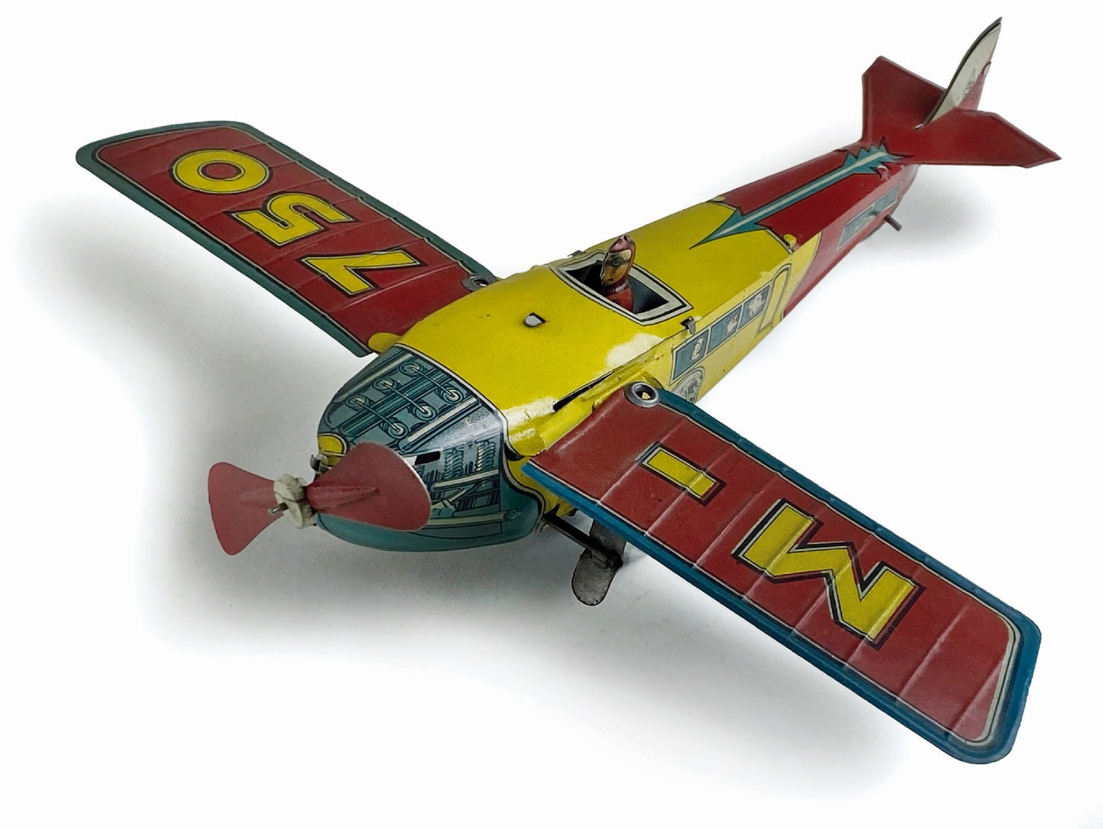 Aeroplano M-750: Ditta Ingap, Italia, 1933. Latta litografata. Cm 22x23x6. Meccanismo a molla con chiavetta inte­grata, elica girevole e ali pie­ghevoli. Eccellente stato, funzionante. (Cfr Avions-Jo­uets des Origi