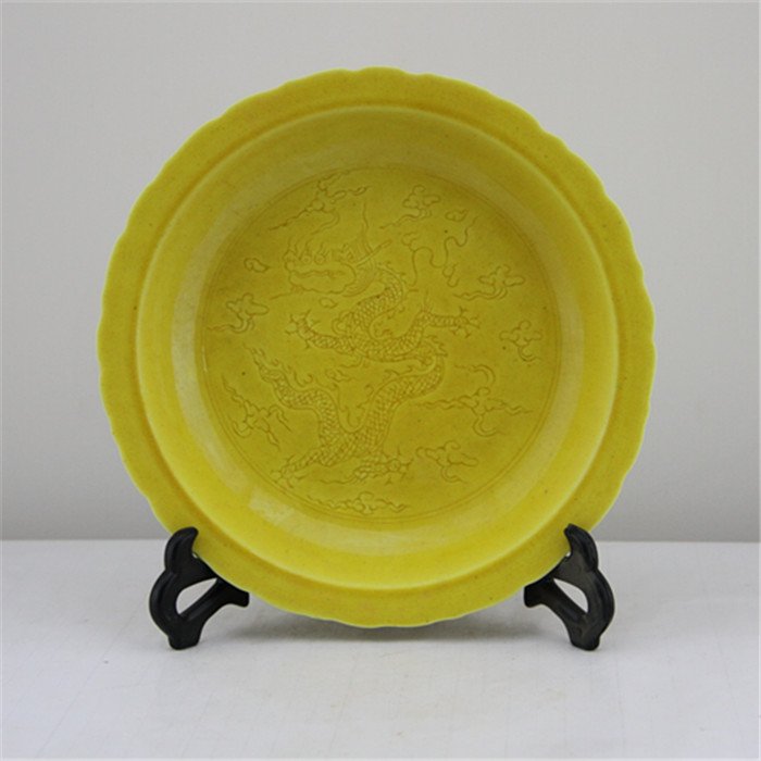 Ming Hongzhi Yellow Glaze Plate: Ming Dynasty, Hongzhi mark and period. With nice carvings- flying dragon in the clouds. Size is H4.5cm, D22cm.