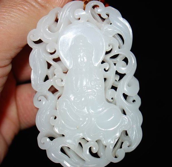 A Nice Antique White Jade Guanyin Pendant: Qing Dynasty, Hetian white jade, mutton fat grade white. Size is around 6.5x4x0.6cm.