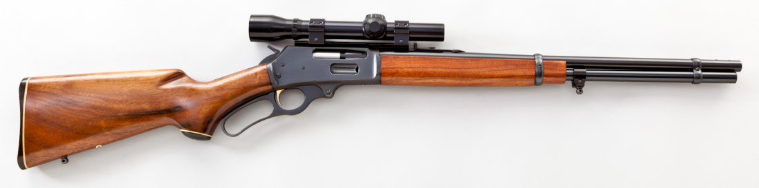 Marlin Model 336 Lever Action Rifle: Marlin Model 336 Lever Action Rifle, #26004087, .30-30 cal., 20'' barrel, blue finish, smooth walnut stock, topped with a Weaver Classic 300 scope. Condition is excellent showing little use, with slig