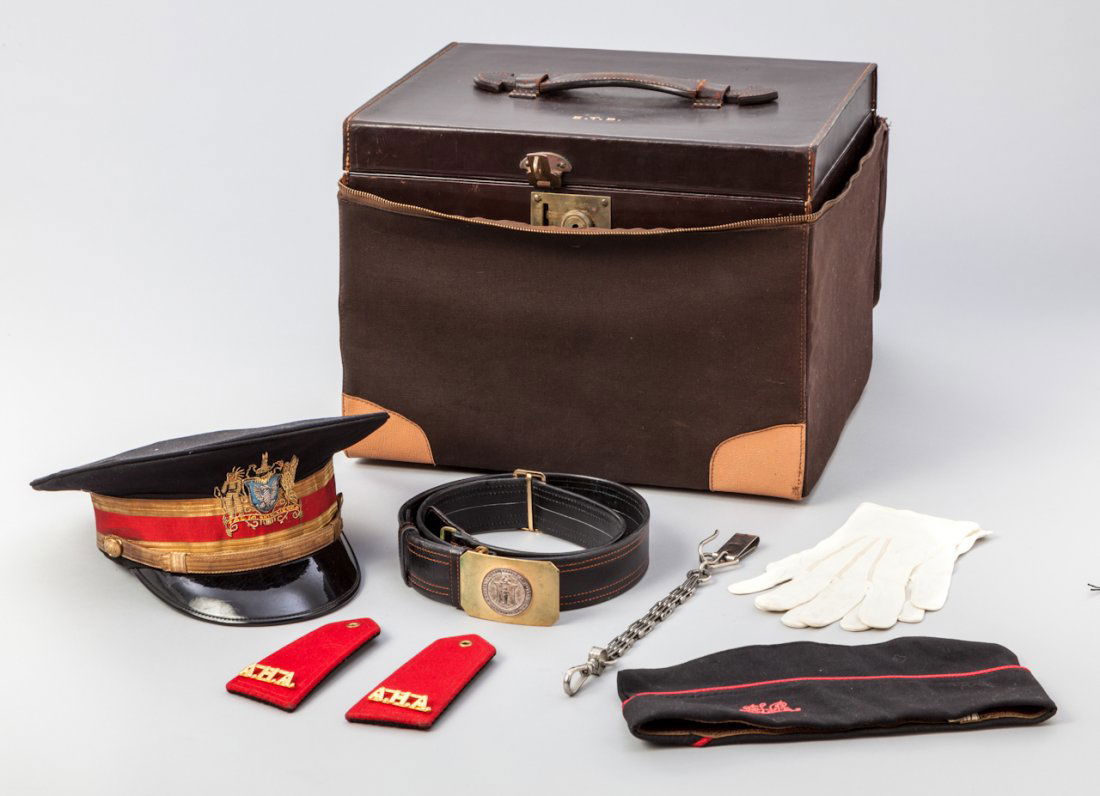 Leather Covered Hat Box: Mid-20th Century Leather Covered Hat Box, by Brooks Brothers, containing a peaked visor, garrison type hat, belt, epaulets, gloves, sword hanger, and weatherproof hat cover, belonging to member of the