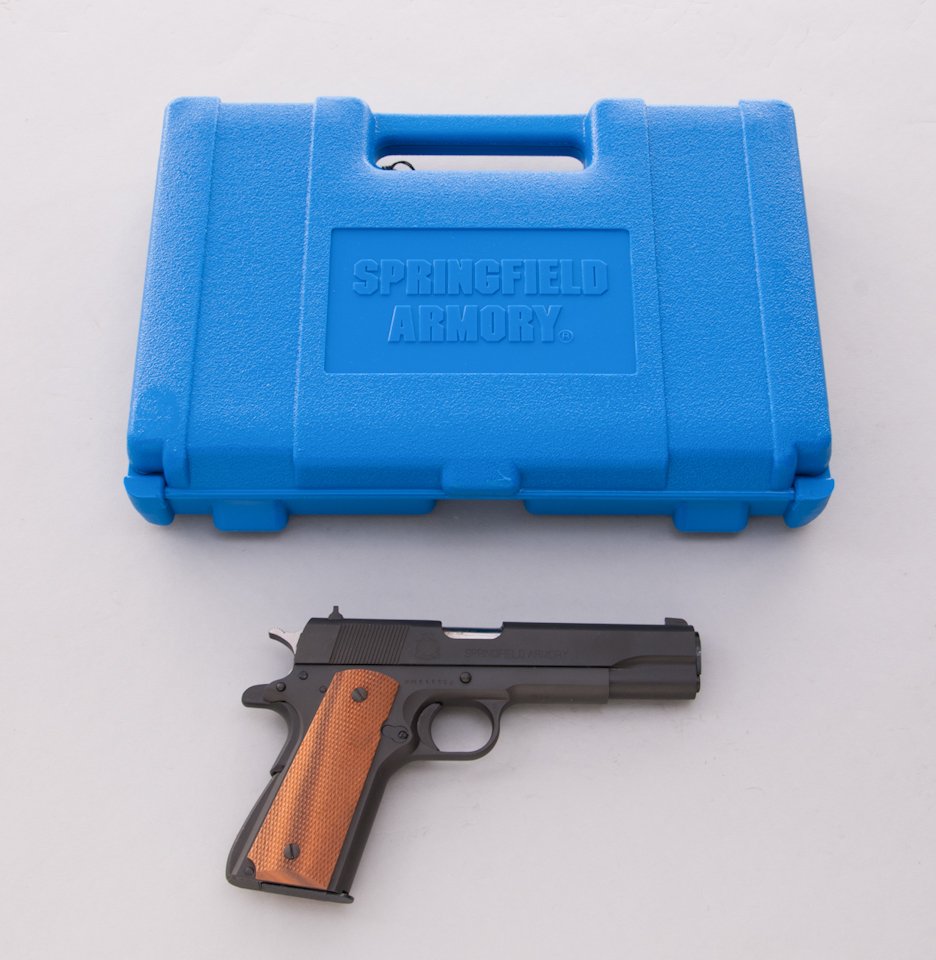 Springfield Armory Model 1911-A1 Semi-Auto Pistol: Springfield Armory Inc. Model 1911-A1 Semi-Automatic Pistol, #NM111392, .45 ACP cal., 5'' barrel, parkerized finish, factory checkered walnut grips. In original blue plastic hard case,, hang tags, cle