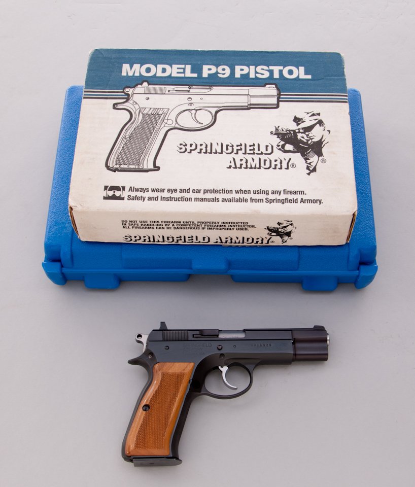 Springfield Armory Model P9 Semi-Automatic Pistol: Springfield Armory Inc. Model P9 Semi-Automatic Pistol, #AM16926, 9mm, 4-1/2'' barrel, blue finish, checkered walnut grips. In original cardboard box with one extra magazine, all instructions, and add