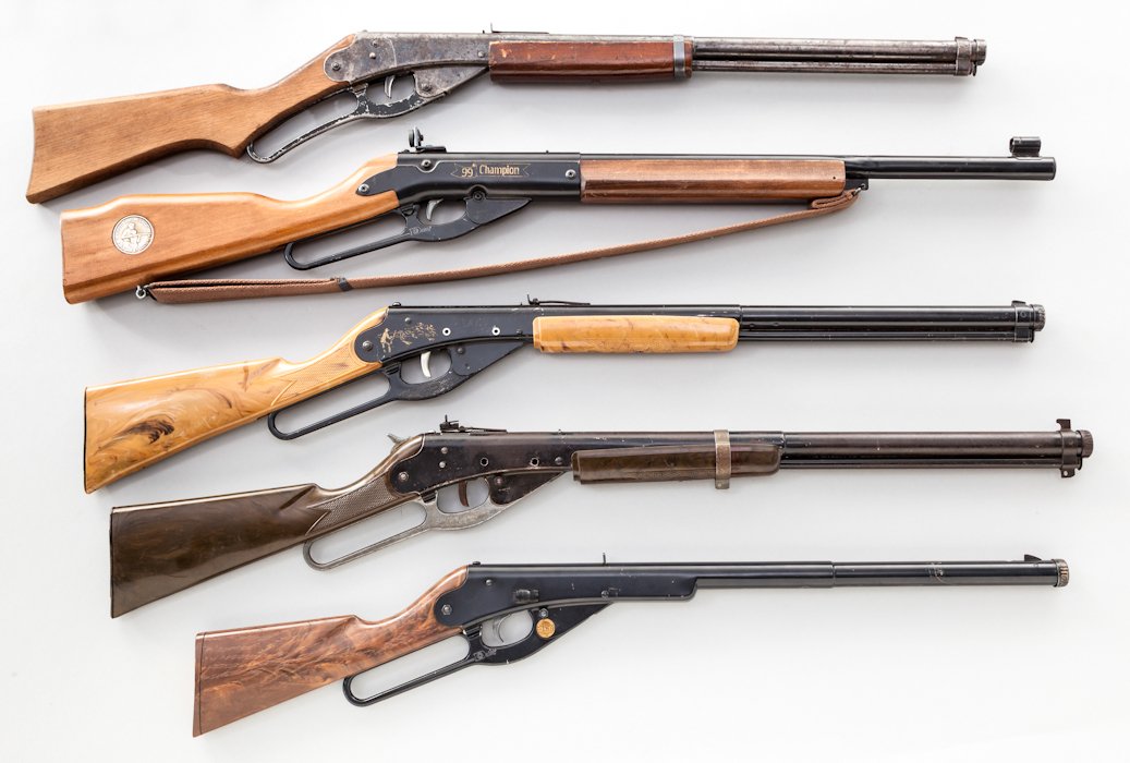 Lot of 5 Daisy BB Guns: Lot of Five (5) Daisy BB Guns: (1) Model 94 Red Ryder Carbine, Plymouth address. (2) Model 99 Champion with peep sight. (3) J.C. Higgins marked Cactus Carbine. (4) Model 111-40 Red Ryder Carbine, Vari