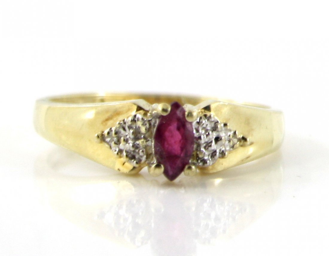 10KT GOLD .10CTW GARNET MARQUISE DIAMOND RING: A very fine 10kt gold .417 purity. This ring features 0.10ctw Garnet Marquise shaped antique design set ring with 0.02CTW set diamonds between the Garnet stone, This ring is a true antique and all the