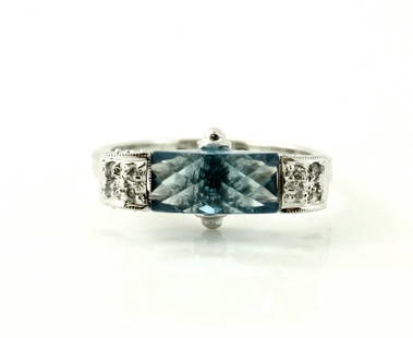 14KT WHITE GOLD DIAMOND BLUE TOPAZ FANCY RING: A very fine High fashion 14kt solid white gold, blue topaz, diamond ring. This ring features a gorgeously cut London blue topaz in the center that is so uniquely cut. The sides of the blue topaz are s