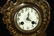AN ANTIQUE BRONZE CLOCK - 5