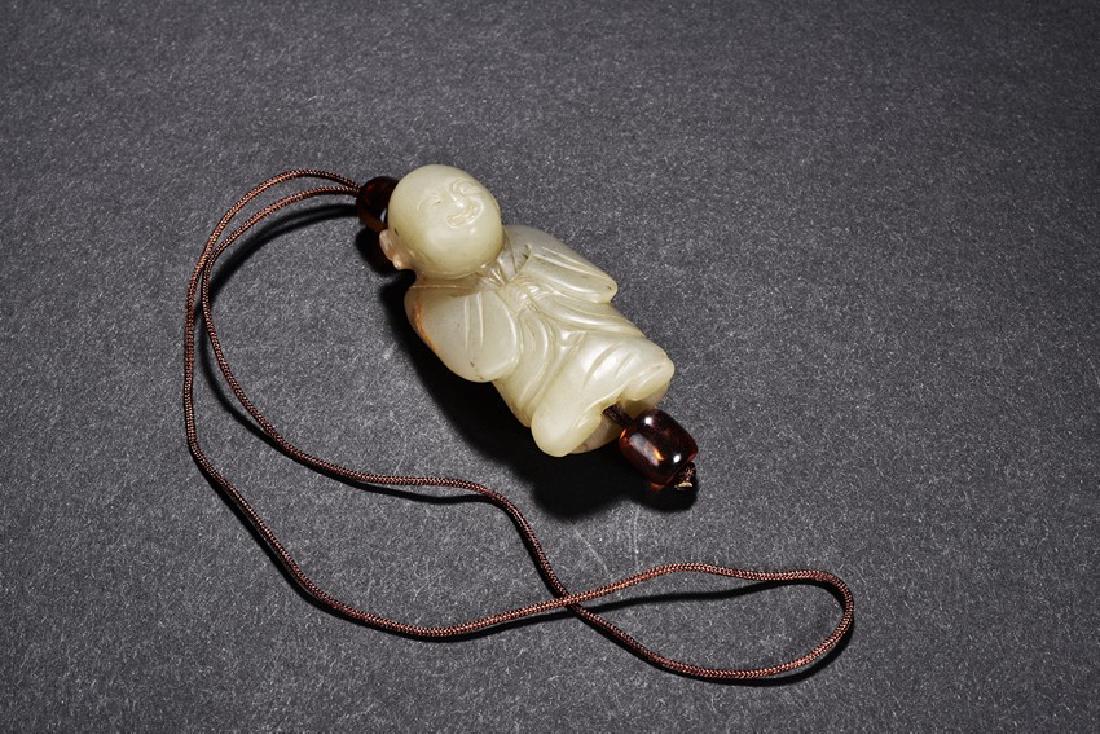 A CELADON JADE FIGURE PENDANT (1 of 10)
