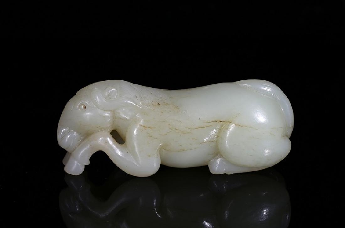 A WHITE JADE CARVED RECUMBENT HORSE (1 of 5)