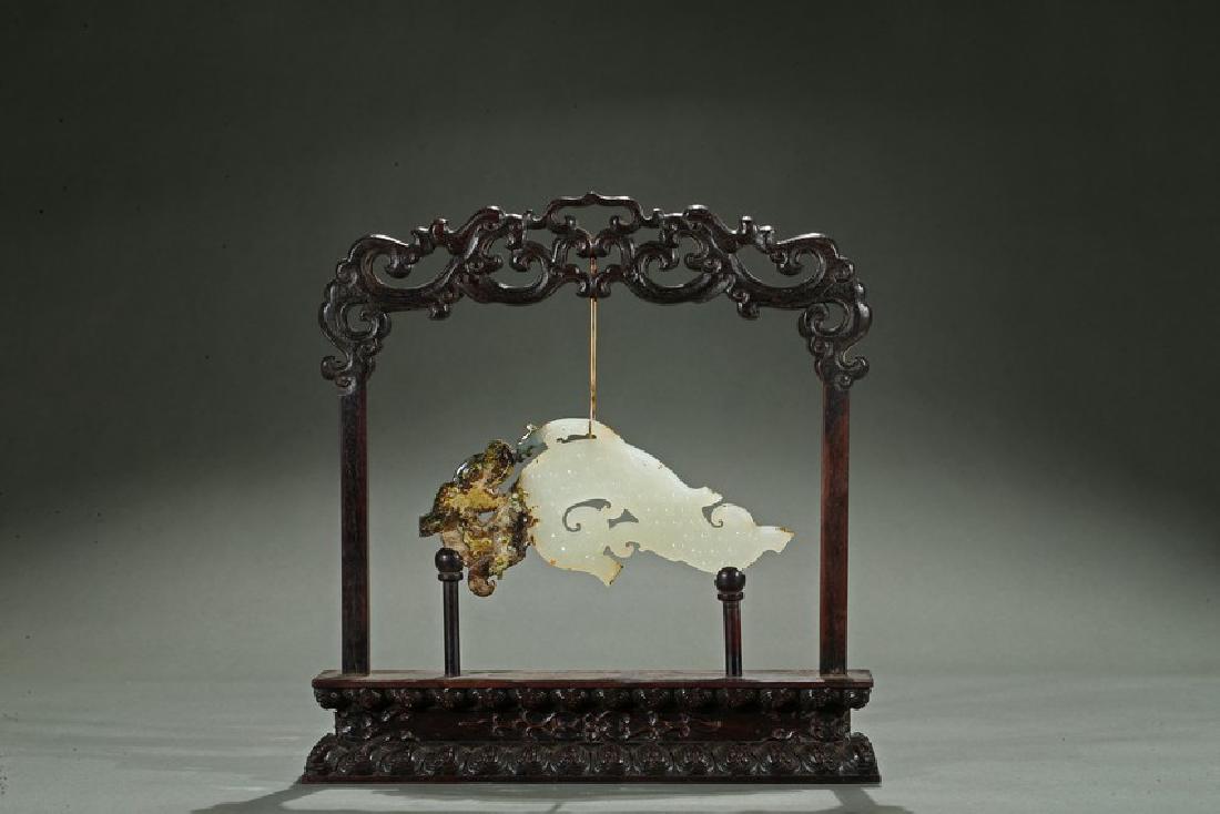 AN ARCHAIC WHITE CALCIFIED 'CHILONG' JADE PENDANT (1 of 5)