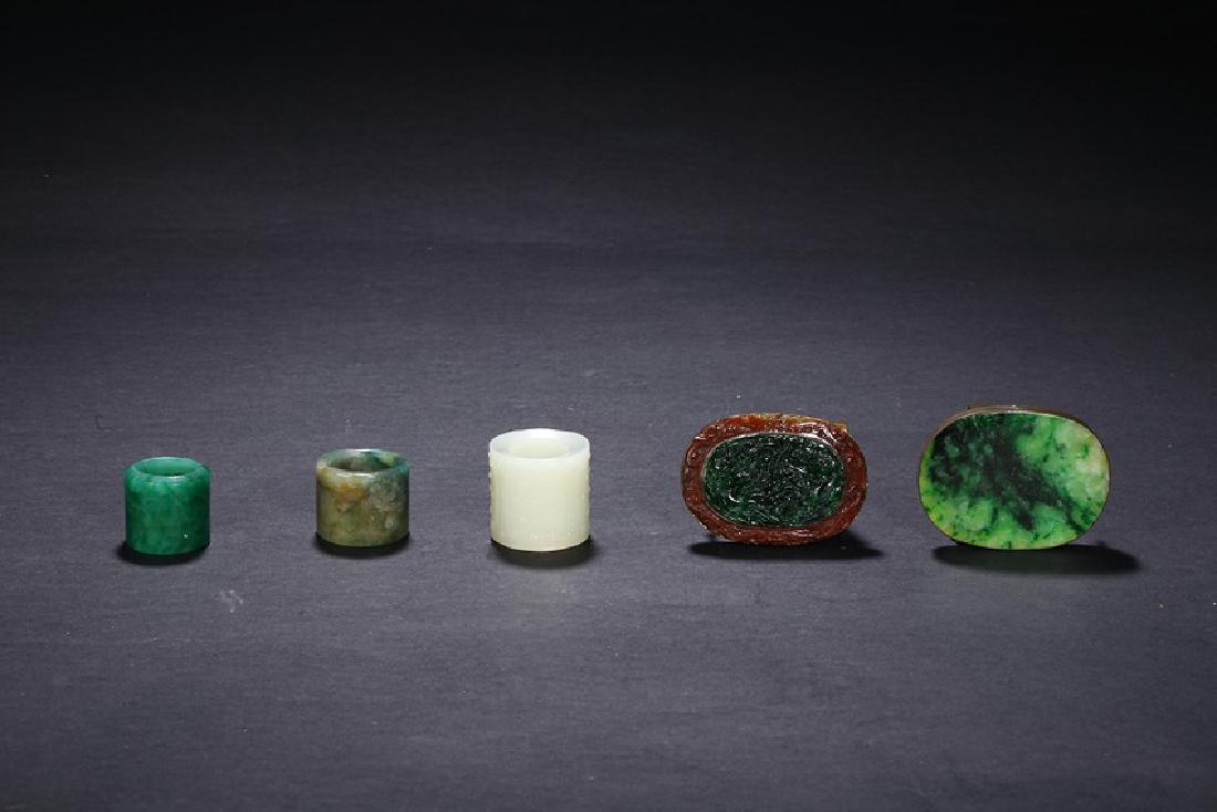 A GROUP OF FIVE CHINESE JADEITE RINGS AND BUCKLES (1 of 9)