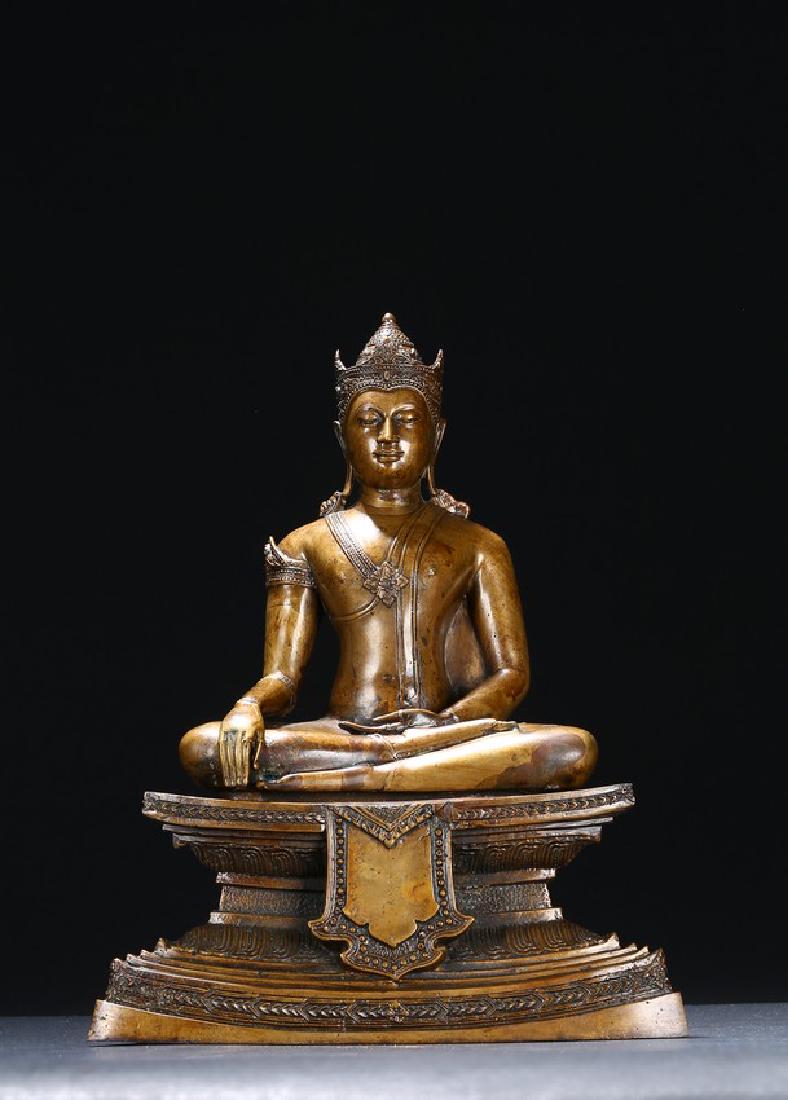 A BRONZE FIGURE OF SEATED BODHISATTVA: The figure is shown seated in dhayanasa on a concave plinth, the hands in bhumisparsha mudra and dhyanamudra, wearing dhoti with incised hem, the face with a serene expression and head framed by an el