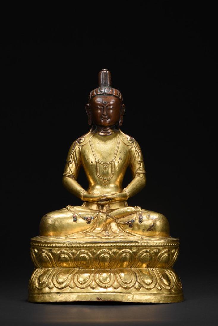 A GILT-BRONZE FIGURE OF AMITABHA: The bodhisattva is shown seated upon a double lotus throne in dhyanasana,hands in dhyana mudra,wearing loose robe and revealing the adorned chest,face with benevolent expression and topped tall ushnis