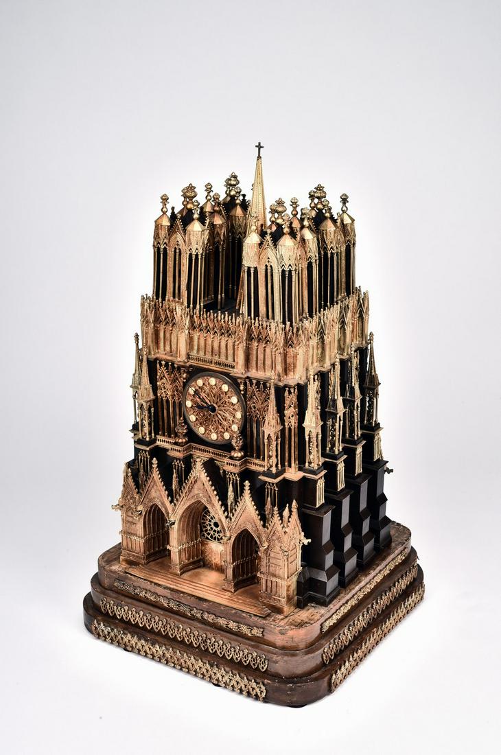 A RARE FRENCH 'REIMS' ORMOLU BRONZE CLOCK: 19th century.The clock modelled realistically in the form of Cathedrale de Reims in France with superb details, it is supported on an mounted step base and includes pendulum measuring clock dimension