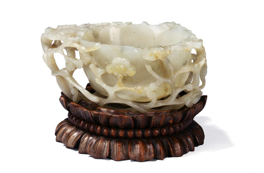 A CHINESE WHITE JADE 'PLUM BLOSSOM' WASHER (1 of 7)