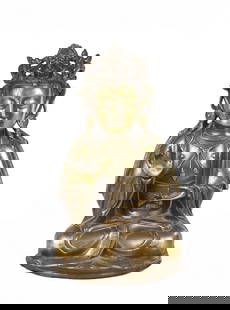 A CHINESE GILT BRONZE FIGURE OF SHAKYAMUNI: Seated in dhyanasana wearing a long flowing robe open at the chest to reveal an elaborate necklace,the face with almond-shaped eyes beneath high arched brows and above a bud mouth,all surmounted by a