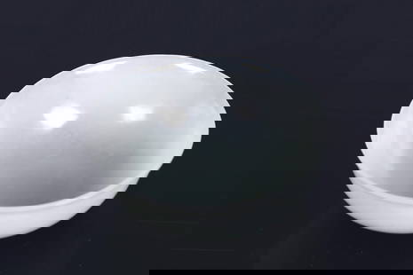 A CHINESE WHITE JADE BOWL: The bowl is carved with flaring sides rising to a slightly everted rim, supported on a circular ring foot. The stone is of a semi-translucent, even white tone. Qing Dynasty period. Height: 2 1/4 in (5