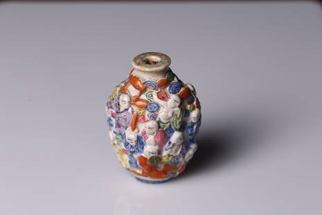 A FAMILLE ROSE MOULDED 'IMMORTALS' SNUFF BOTTLE: Decorated in relief with various immortals, with stopper. Qing Dynasty period. Height: 2 3/4 in (7.0 cm) Width: 2 in (5.1 cm) Provenance: Property from a private collection in East Los Angeles