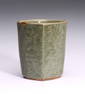 A CHINESE CELADON GLAZE MOULDED CUP