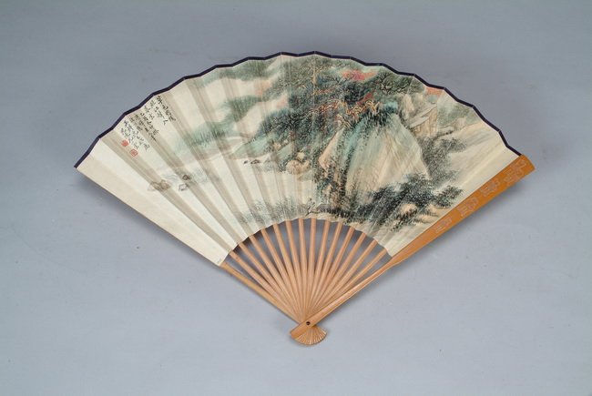 A Chinese "Scenery and poem" fan: One side has paintings of a man rowing out of the river near mountains, other side has calligraphy; artist mark "YOU XIAOYUN". Spread: 19 1/4 in (49 cm ), L: 12 1/4 in (31 cm )