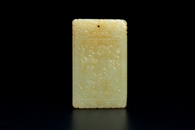 A CHINESE JADE "ZIGANG" PENDANT: This jade pendant, on one side features two boys playing Chinese clash cymbals under a pine tree, and reverse carved with fifteen Chinese characters. The upper part of the pendant was decorated with t