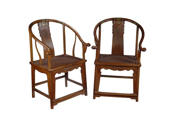 A PAIR OF CHINESE HUANGHUALI HORSESHOEBACK ARMCHAI: The curved top rail of each set above gently curved splat with beast design and terminating in the front corner posts, supported on curved stiles on either side. The seats set into the rectangular fra