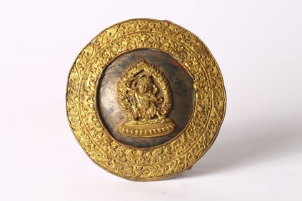 A Tibetan Gilt Bronze Repousse Achala Ritual Shield