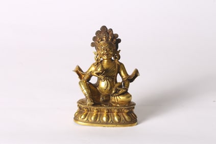 A Gilt Bronze Figure of Seated Jambhala