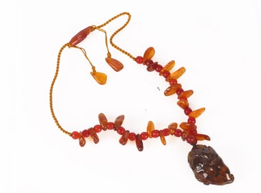 A Chinese Amber Necklace and Pendant